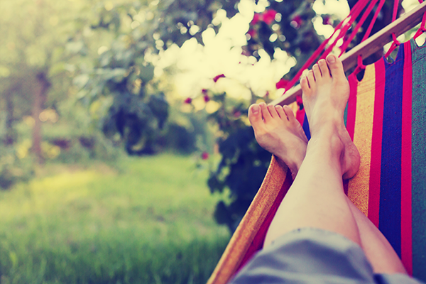 Person relaxing in a hammock in their garden