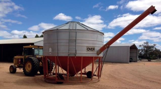 Portable field bin attached to a tractor