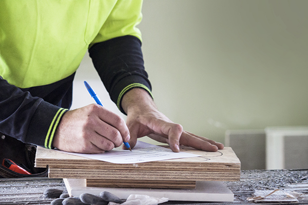 Construction worker completing paperwork